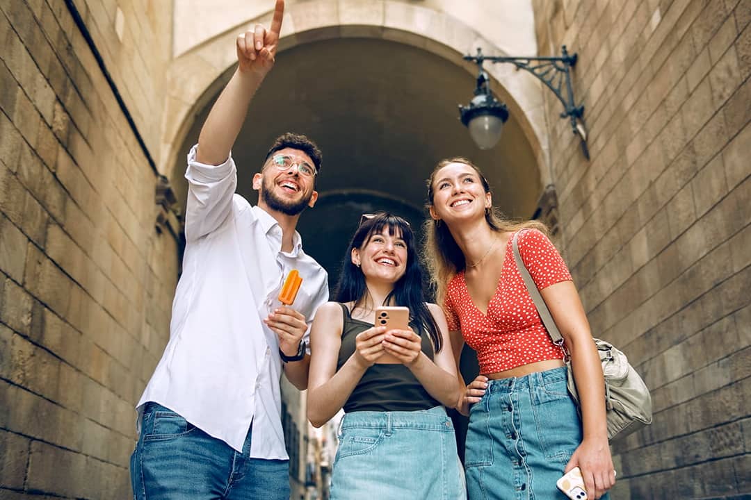 A group of three friends out and about sightseeing in a city.